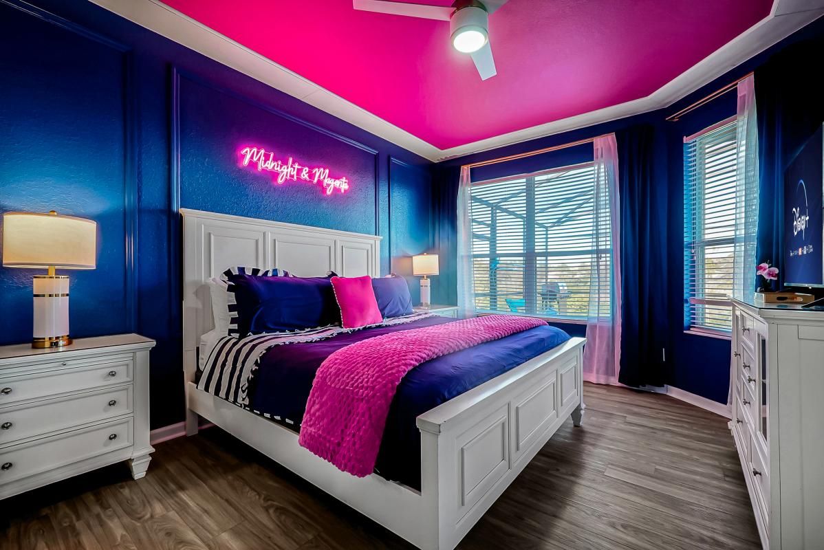 Bold owner suite with plush king bed, dramatic palette, neon accent, and private en-suite. ✨