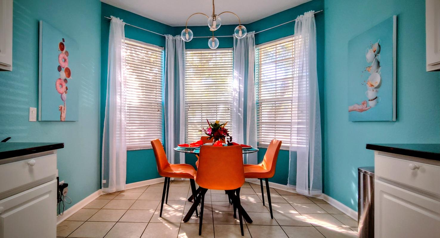 Sunny breakfast nook with comfy seating?perfect for quick bites, coffee, and planning park days.