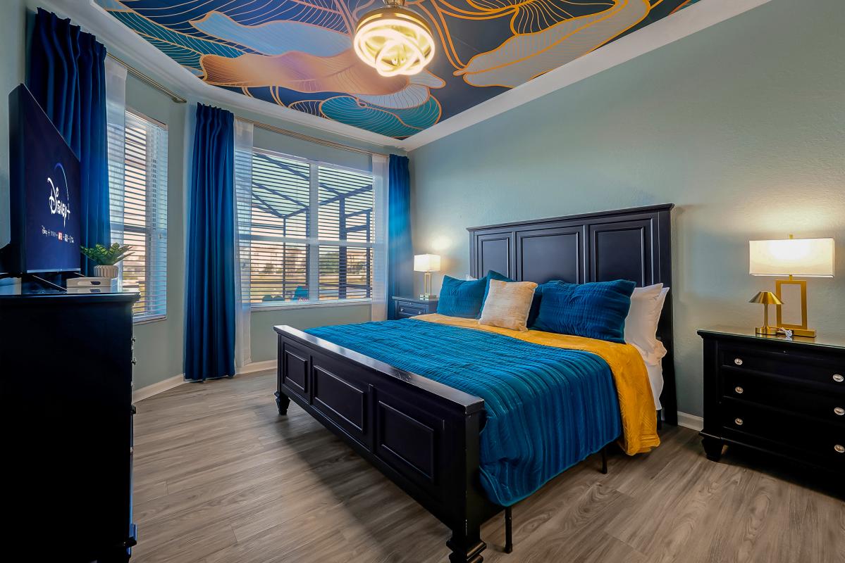 Serene tropical suite with plush king bed, statement ceiling, smart TV, and private en-suite.