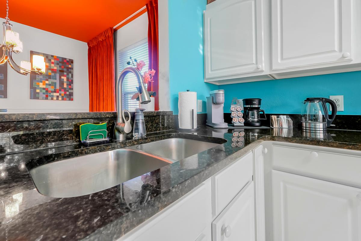 Bright, fully equipped kitchen with stainless appliances and a coffee bar featuring Keurig + drip.