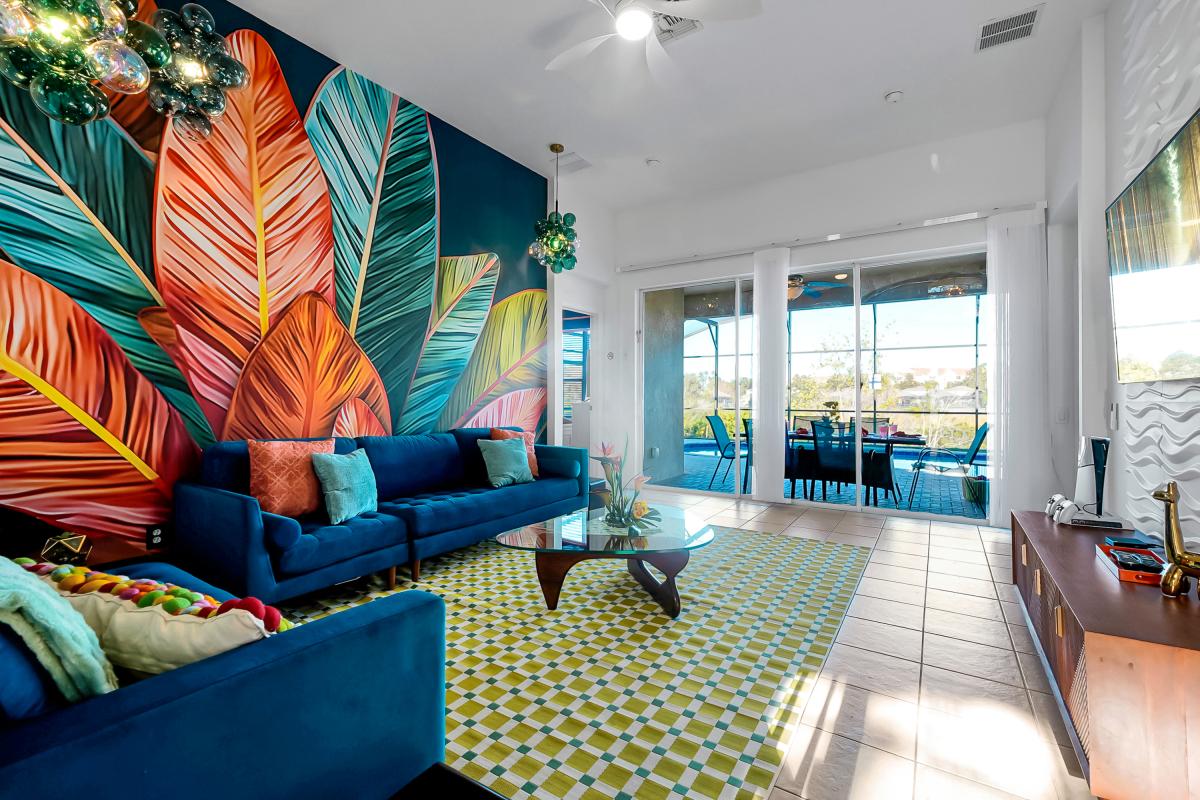 Bold living room with vibrant mural art, plush seating, and a PS5?perfect for relaxing or gaming tog